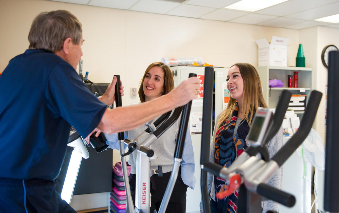 Practicum student Sydney Riglin, right, started a new initiative that encourages male cancer survivors to get physically active. She and Kinesiology prof Nicole Culos-Reed talk with participant John Gosbee. Photos by Riley Brandt, University of Calgary