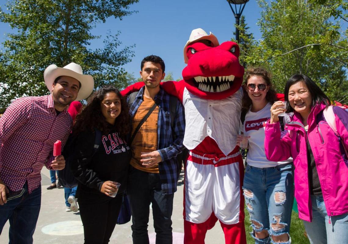 Rodeo Rex poses with attendees at the President's Stampede Barbecue.