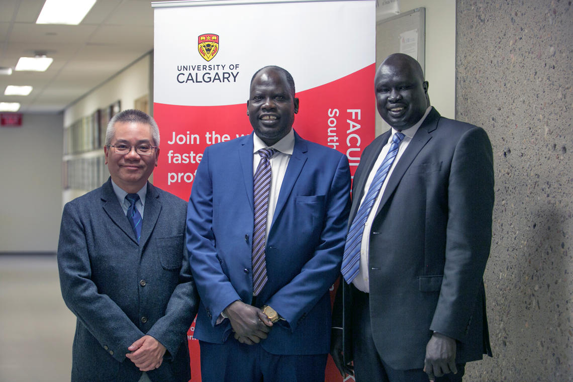 Samuel Mathon, centre, and John Manyok, right, survived war and deprivation to come to Canada, learn English, and graduate from the University of Calgary as social workers. With them is Dr. Siu Ming Kwok, associate dean of the Faculty of Social Work’s Southern Alberta Region.