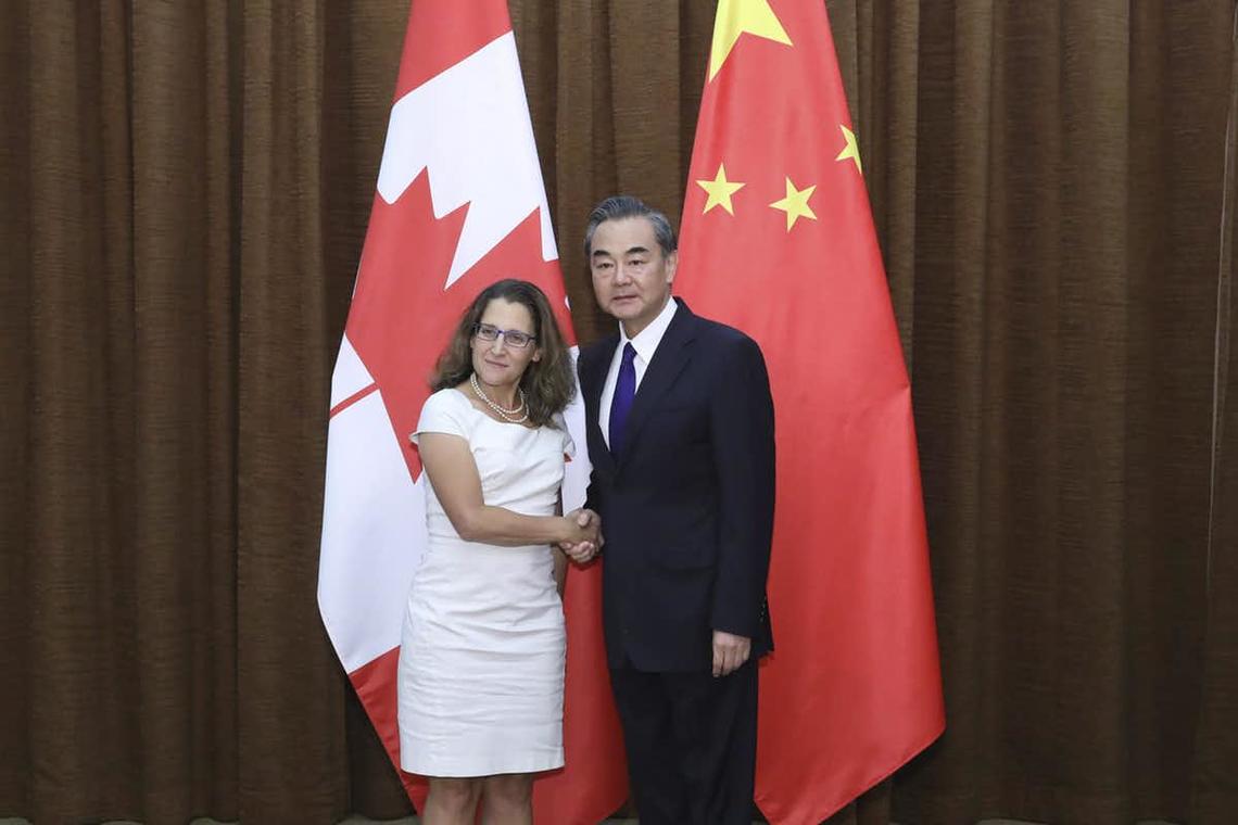 Chrystia Freeland poses with China’s Foreign Minister Wang Yi as she arrives for a meeting at the Ministry of Foreign Affairs in Beijing in August 2017. 