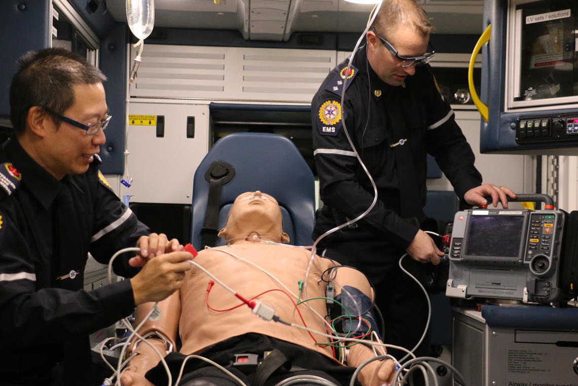 Two paramedics are working on a patient in this simulation that was part of the UCalgary/EMS study. One paramedic is wearing the eye tracking technology.