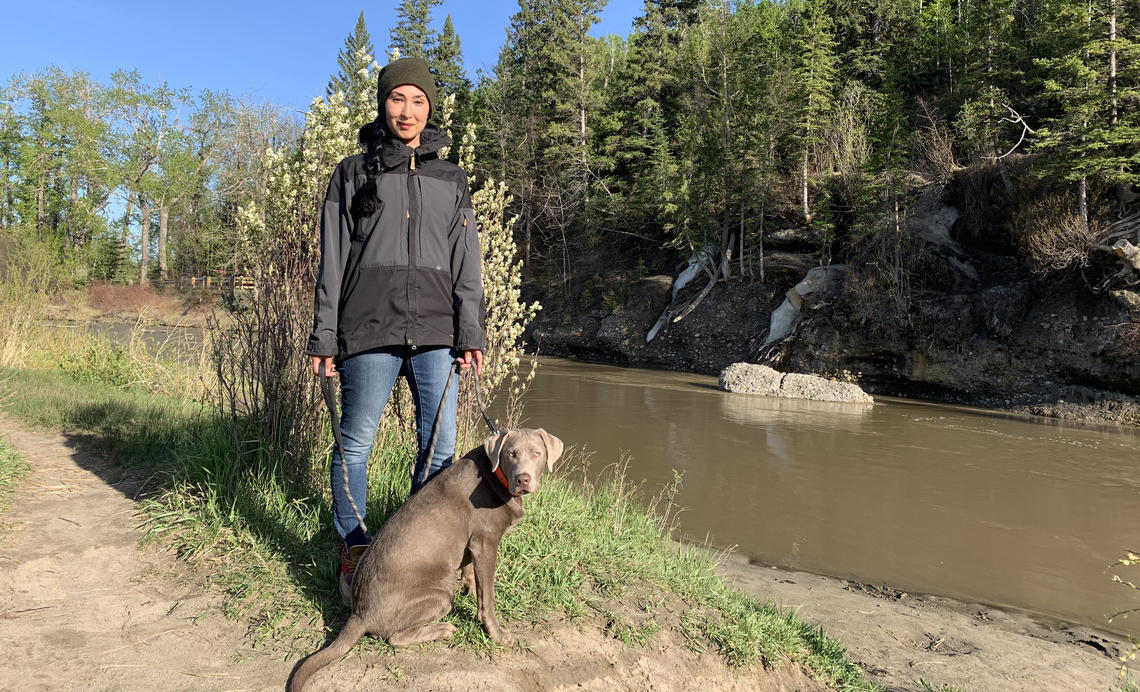 Graduating with an MA in Geography, Kristy Myles enjoys a walk in Fish Creek Park with her dog, Whiskey.