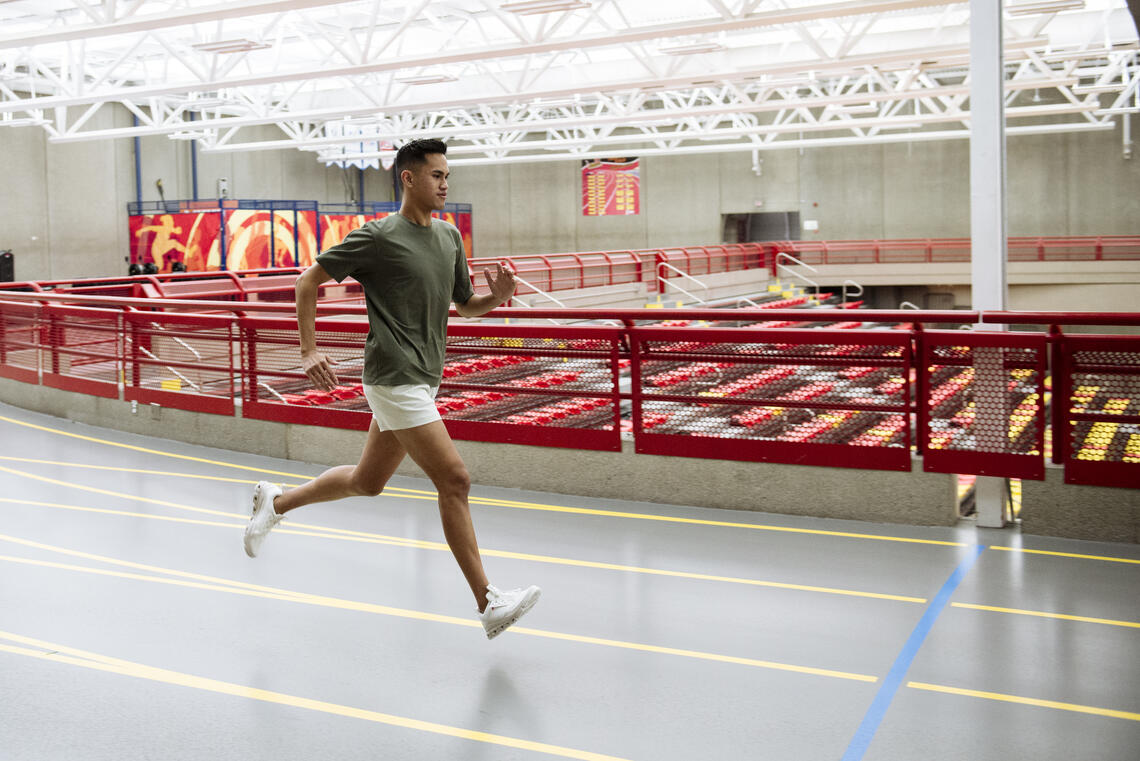 Nick Basilio runs on the track in the Jack Simpson Gym.