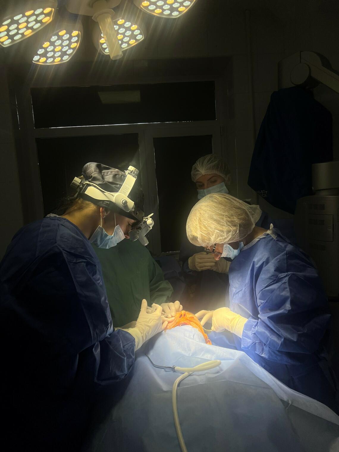 Surgeons performing surgery in the dark