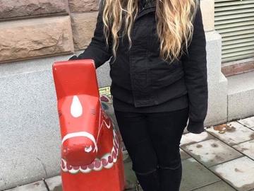 Emily Tetrault with red wooden Dala Horse 