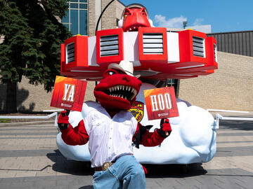 Rex shows his Stampede spirit in front of the brand new UCalgary float featuring him.