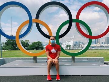 Girl in front of Olympic rings