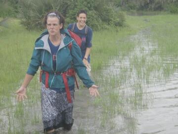 Alida walking through swamp to worksite in South Sudan.