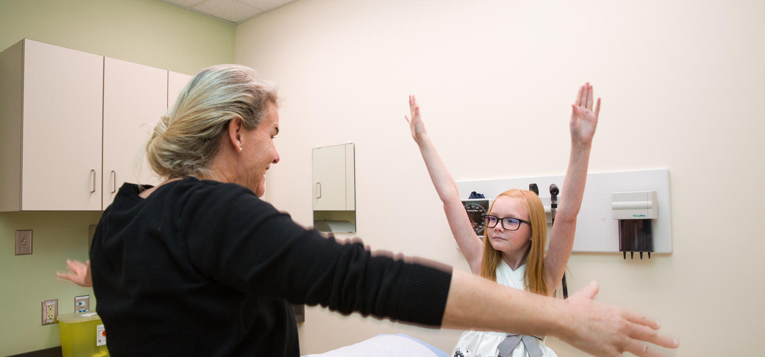 Dr. Susanne Benseler leads Kayla Baayens in mobility tests. The 10-year-old has an aggressive form of childhood arthritis. Benseler is part of an international team that received $8 million in grants to bring precision medicine to children suffering from childhood arthritis. Photo by Riley Brandt, University of Calgary