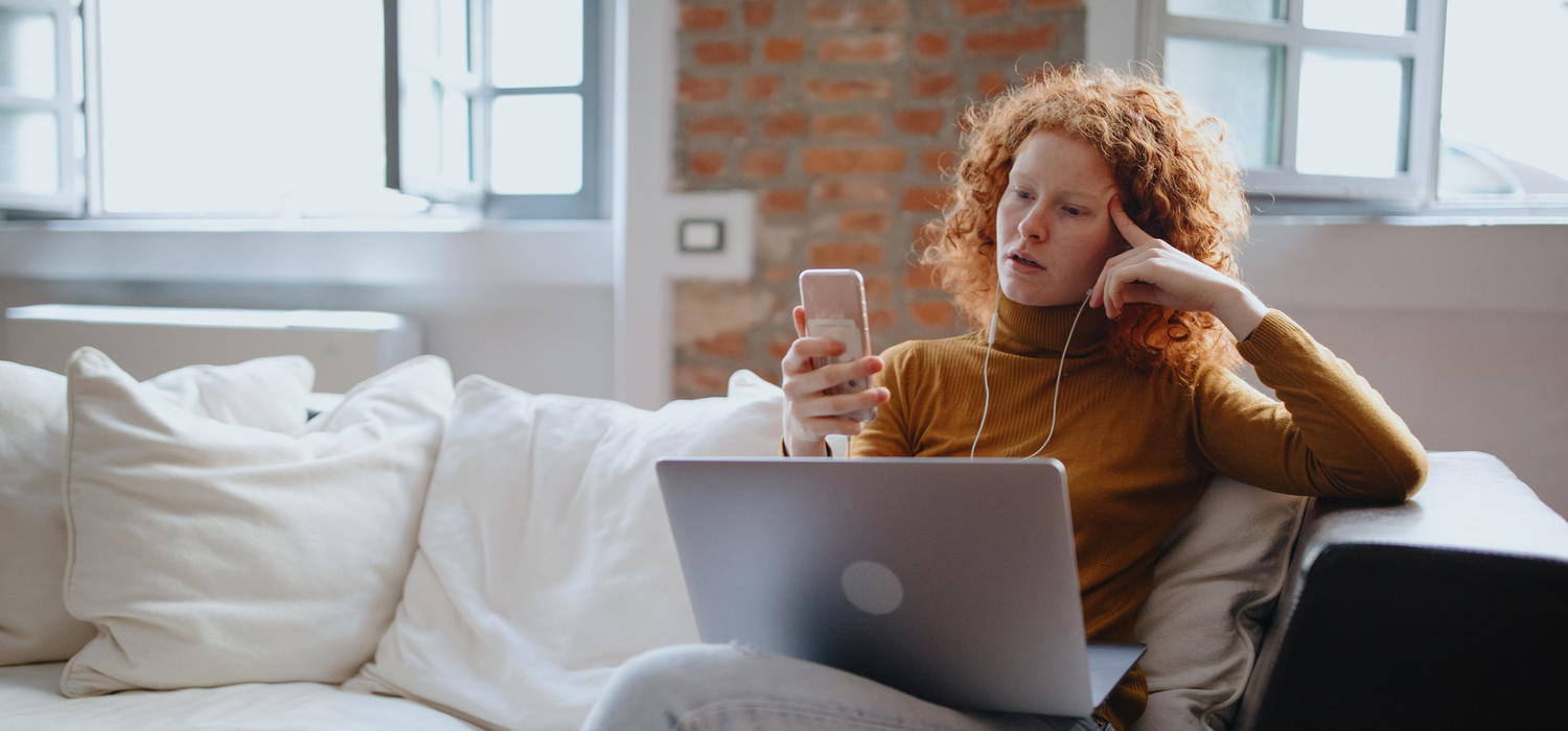 Woman on laptop and phone