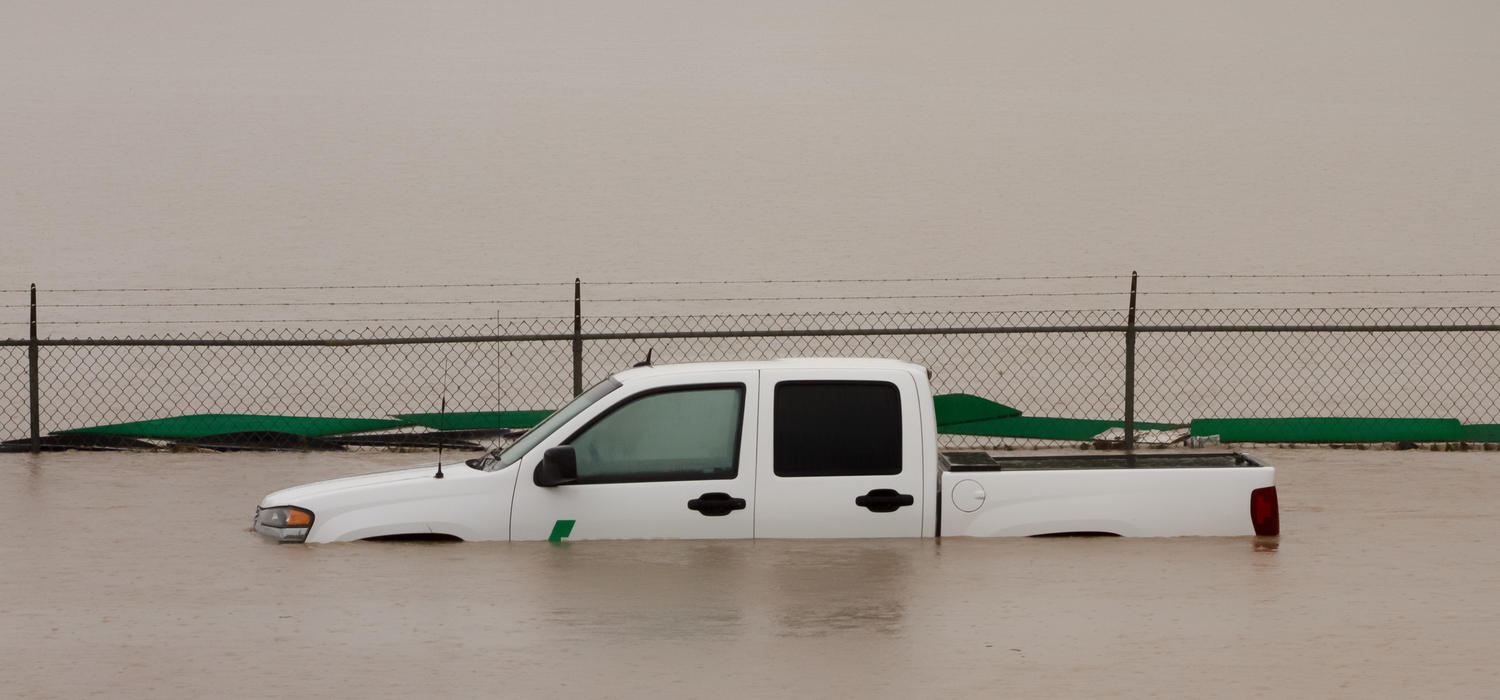 Pick-up truck half submerged in flood water