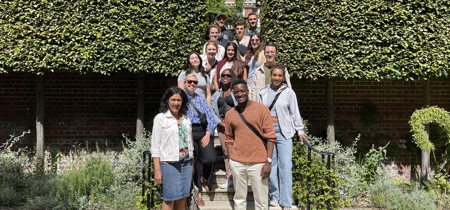 The London Program 2023 participants standing in front of a bush.