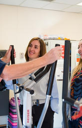 Practicum student Sydney Riglin, right, started a new initiative that encourages male cancer survivors to get physically active. She and Kinesiology prof Nicole Culos-Reed talk with participant John Gosbee. Photos by Riley Brandt, University of Calgary