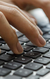 Hands typing on a keyboard