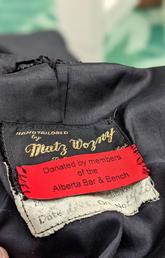Label on a donated robe that reads "Donated by members of the Alberta Bar and Bench."