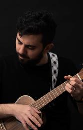 Mustafa Kamaliddin plays his ukulele