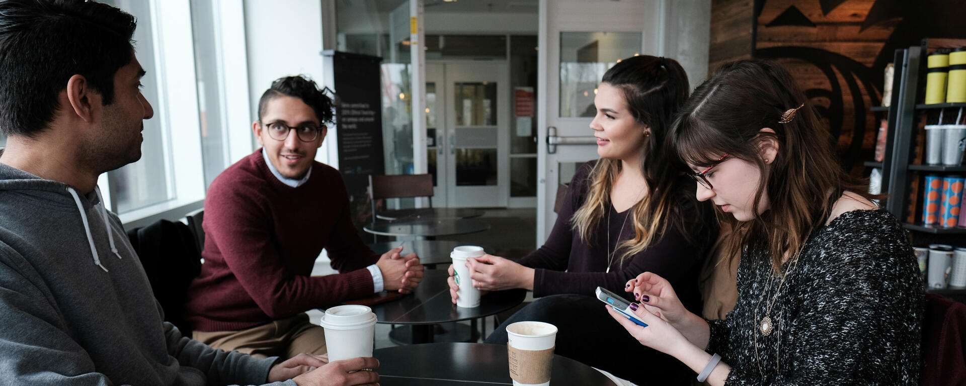students sitting around table drinking coffee