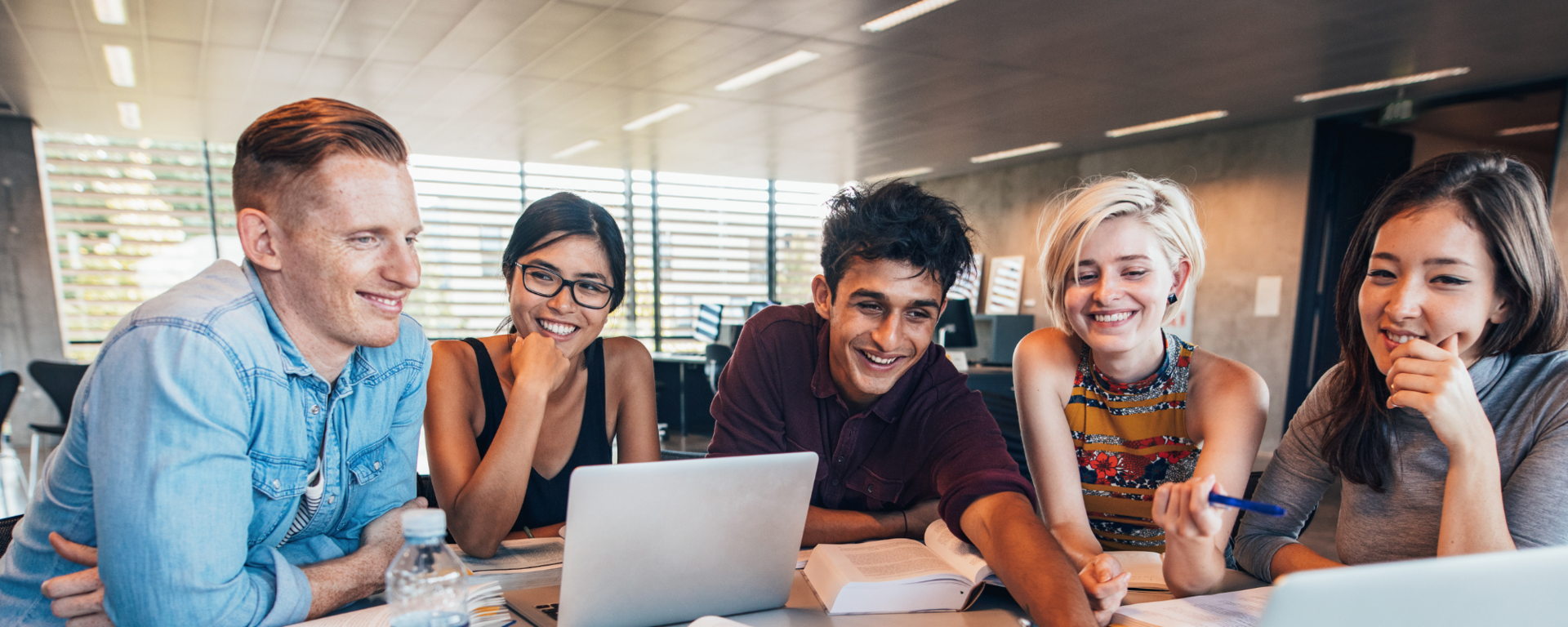 Students looking at laptop computer