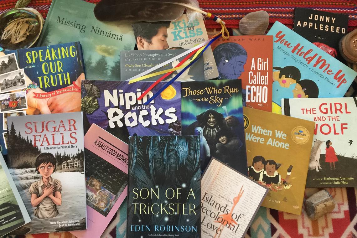 Many Indigenous books on a blanket