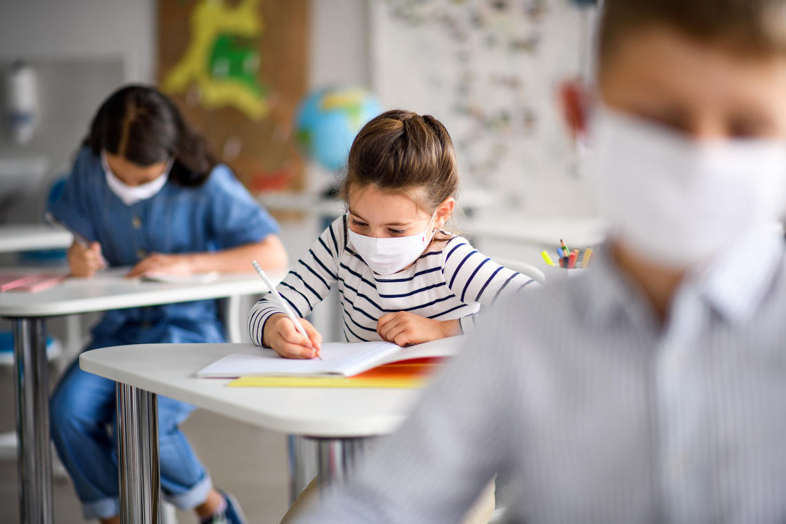 Children in classroom wearing masks