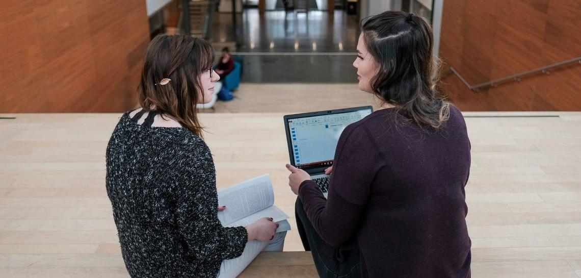 Two Students talking over a computer