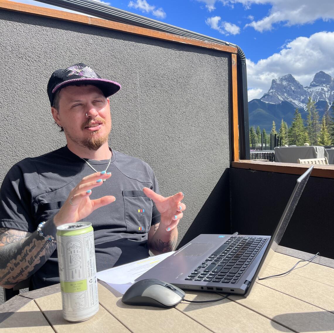 Picture of man in hat mountains in background