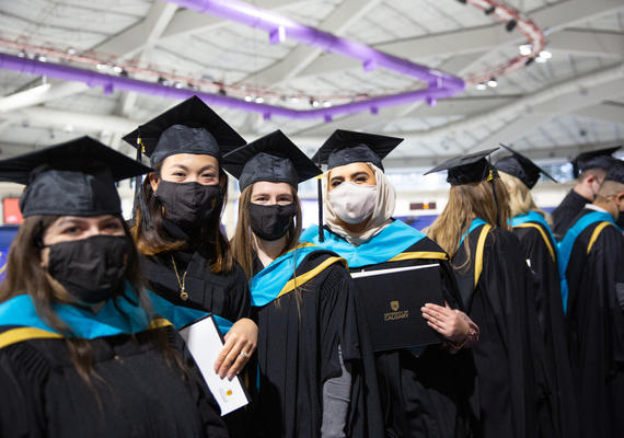Fall convocation students in robes and masks