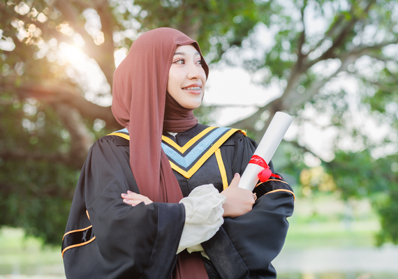 student holding diploma