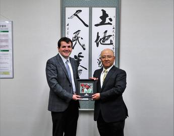 Michael Holden presents a gift to Hokadate Chair