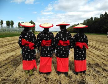 students in traditional Japanese clothes in a field
