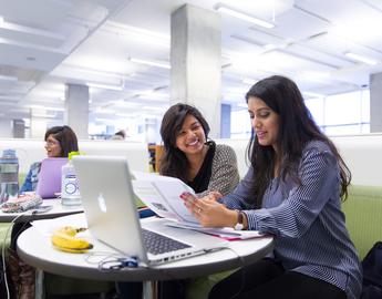 Two students discussing a text