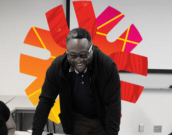 Teacher stnading in front of whiteboard